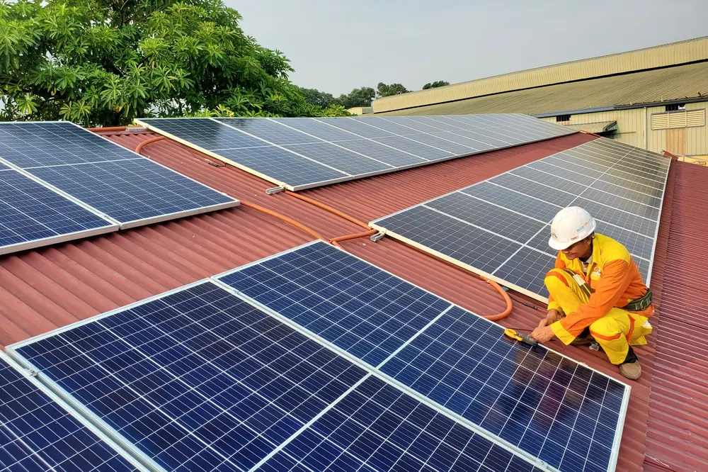 Stock photograph: technician inspecting solar panels on a roof